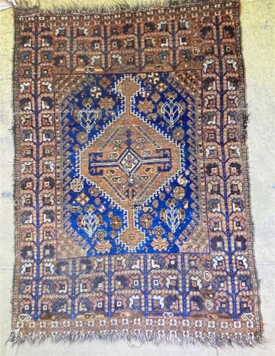 A Caucasian blue ground rug, 128 x 89cm, a Persian style red ground mat and a gold ground rug